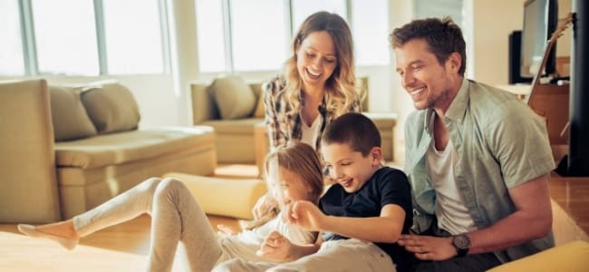 cute family of four sitting on the floor